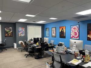 Office featuring a paneled ceiling and light colored carpet