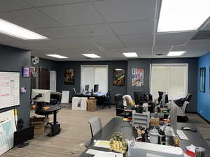 Interior space featuring a paneled ceiling and a desk