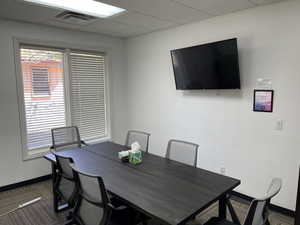 Home office featuring a paneled ceiling and baseboards