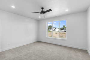 Spare room with light carpet, a ceiling fan, and recessed lighting