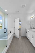 Full bath featuring a bath, a stall shower, light tile patterned floors, and recessed lighting
