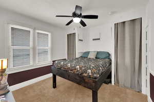 Bedroom with ceiling fan and carpet floors