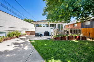 Back of property with a patio area, a sunroom, and a vegetable garden