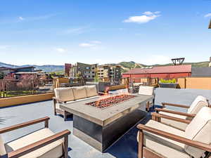 View of patio / terrace with a mountain view and an outdoor living space with a fire pit