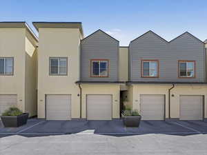 View of front facade featuring stucco siding and an attached garage