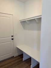 Mudroom featuring dark wood-style floors and baseboards