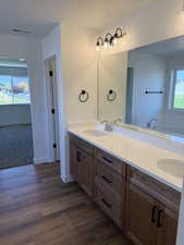 Bathroom with dark wood-style floors, a bath, and a textured ceiling
