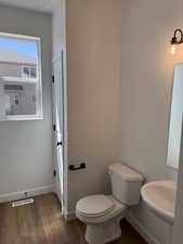 Bathroom with dark wood finished floors and baseboards