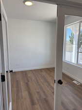 Spare room featuring wood finished floors and a textured ceiling