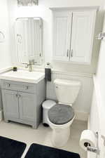 Bathroom with vanity and a wainscoted wall