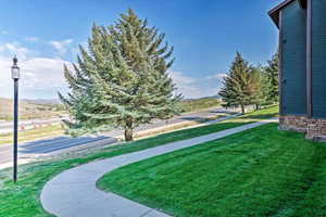 View of community with a lawn and a mountain view