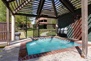 View of pool featuring a patio and a pergola