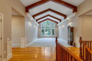 Corridor featuring light wood-style floors and an upstairs landing