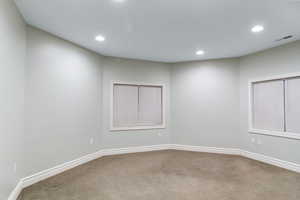 Spare room with light carpet and recessed lighting