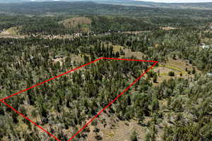 Aerial view of property's location featuring property parcel outlined and a mountain backdrop