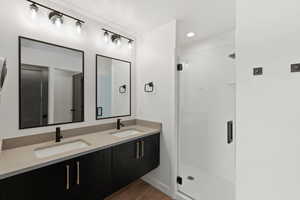 Bathroom with a shower stall, light wood-style floors, and recessed lighting