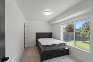 Bedroom featuring light colored carpet
