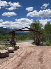 View of property's community featuring a view of trees and a mountain view