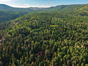 Aerial view of property's location with mountains and property boundaries highlighted