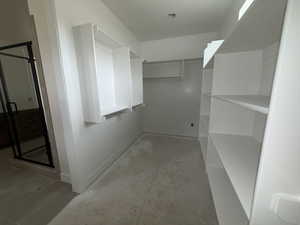 View of walk in master closet