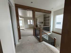 Hallway with an upstairs landing and beam work