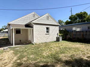 Rear view of property with concrete block siding