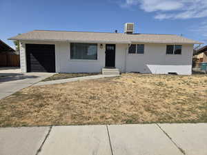 Ranch-style house featuring driveway, brick siding, an attached garage, and roof with shingles