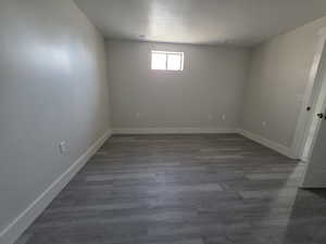 Empty room featuring dark wood finished floors and a textured ceiling