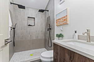 Bathroom featuring vanity and a tile shower