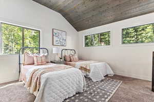 Bedroom featuring lofted ceiling, carpet, and wooden ceiling