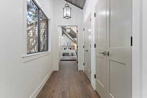 Hall featuring dark wood finished floors and baseboards