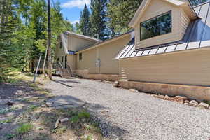 Rear view of house with a metal roof and a standing seam roof