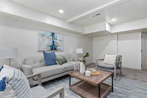 Carpeted living room featuring baseboards and recessed lighting