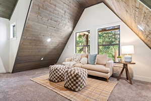 Additional living space with wood ceiling, healthy amount of natural light, carpet flooring, and lofted ceiling