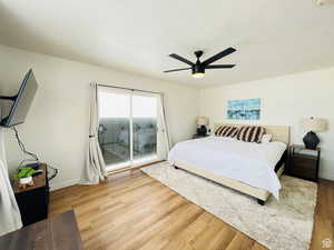 Bedroom with access to outside, ceiling fan, light wood-type flooring, and a textured ceiling