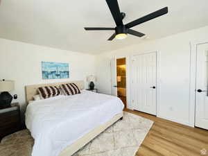 Bedroom featuring a textured ceiling, light wood-style flooring, a ceiling fan, and ensuite bath