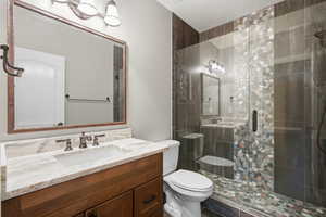 Full bathroom with vanity and a stall shower