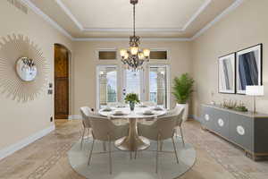 Dining area featuring crown molding, stone tile flooring, arched walkways, a chandelier, and a raised ceiling