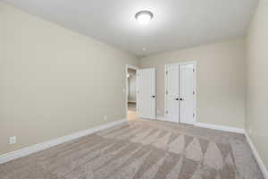 Unfurnished bedroom with carpet floors and a closet