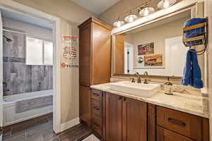 Bathroom featuring vanity, shower / tub combination, and wood finish floors