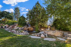 View of yard with a small pond