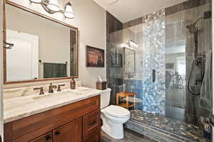 Bathroom featuring a shower stall and vanity