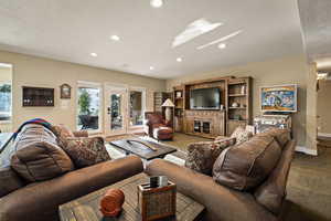 Carpeted living room with recessed lighting and baseboards