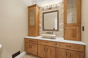 Half bathroom with vanity and baseboards