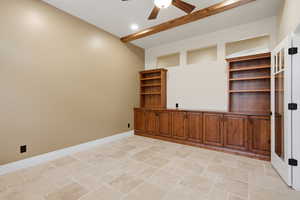 Unfurnished room with stone tile floors and a ceiling fan