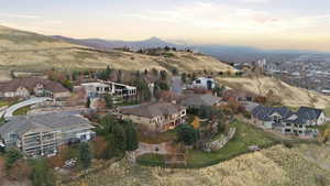 Aerial overview of property's location with nearby suburban area and a mountain backdrop