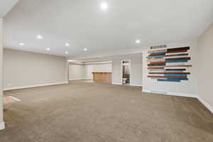 Unfurnished living room with recessed lighting and light colored carpet