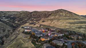 Aerial overview of property's location featuring nearby suburban area and mountains