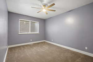 Spare room with carpet and ceiling fan