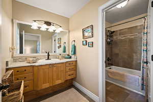 Bathroom with vanity and shower / bath combo